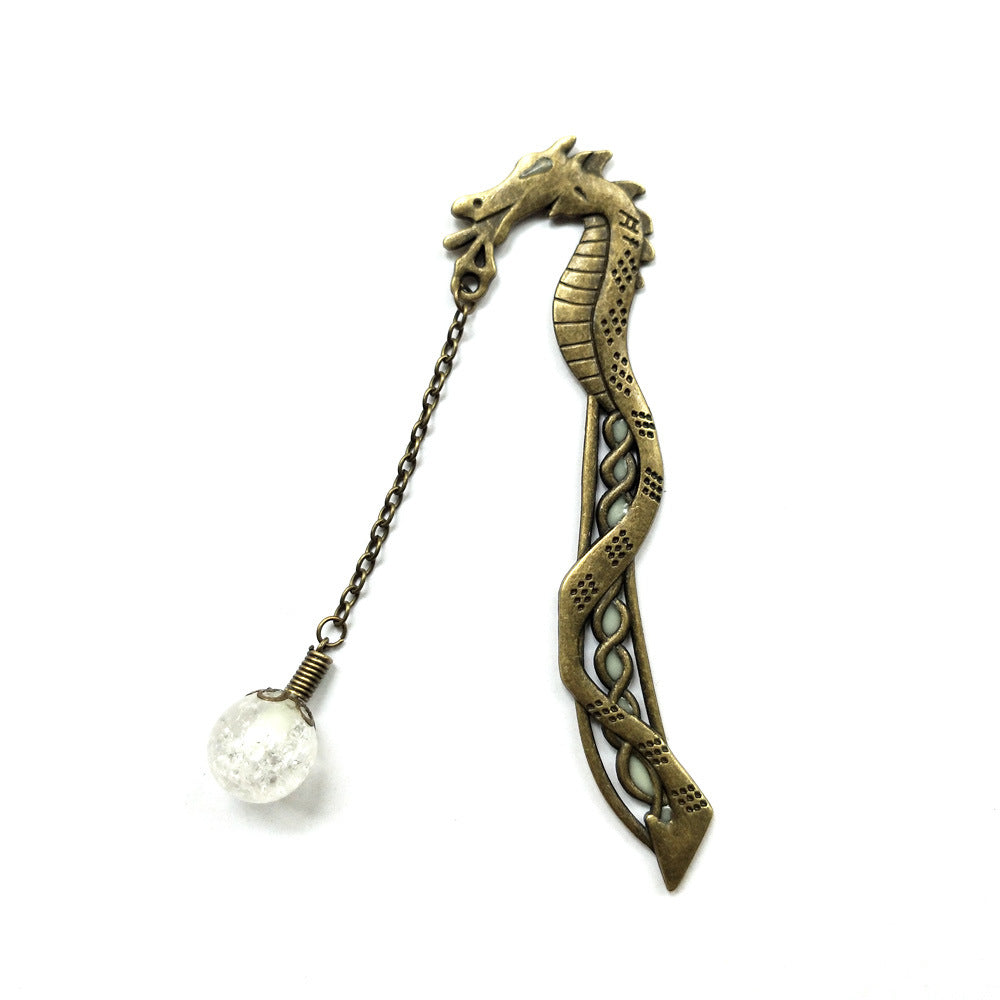 Bronze metal dragon bookmark with chain pendant in daylight