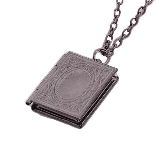 The Storykeeper black storybook photo locket necklace, open showing hinge