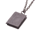 The Storykeeper black storybook photo locket necklace, open showing hinge