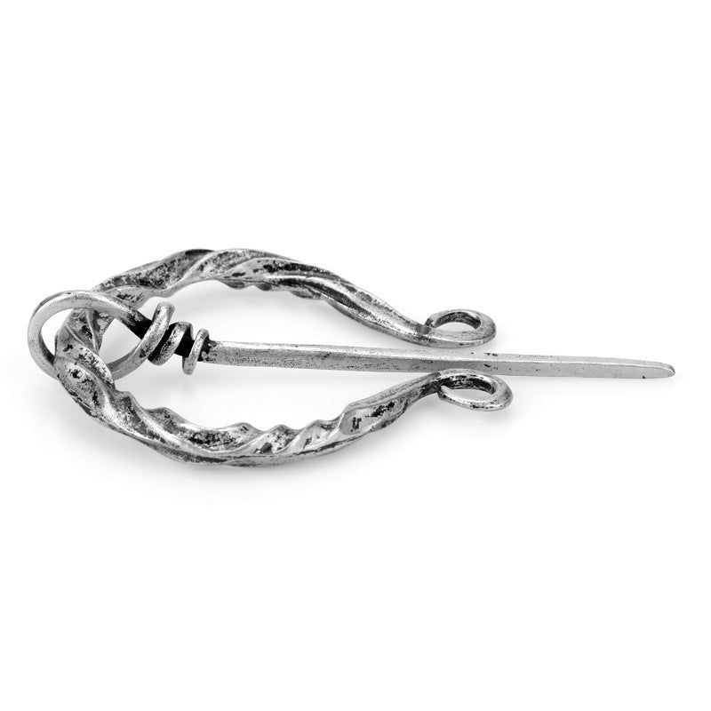 Side profile of the silver knotwork fibula cloak pin showing the coiled loop and pin tension