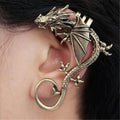 Antique bronze dragon ear cuff worn on the ear, wing spread across the outer ear with coiled tail