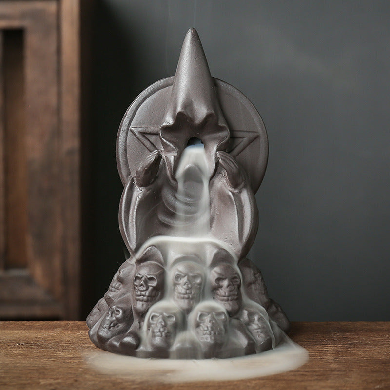 Skull incense burner with backflow cone lit