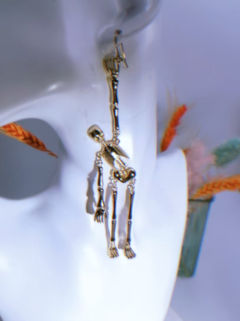 Skeleton dangle earring worn, close-up angle