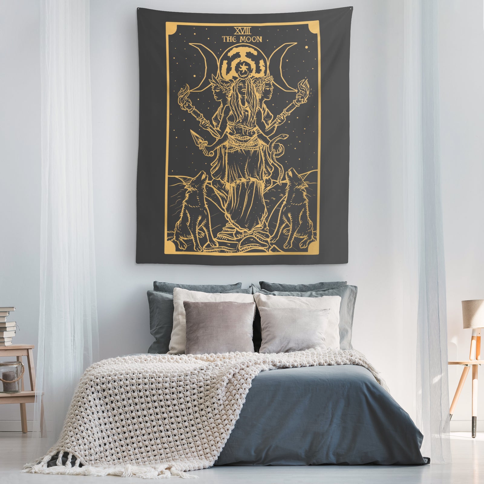 Wide view of the black and gold Hecate moon goddess tapestry as a bedroom wall hanging