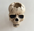 Gravelight skull wall candle holder with a lit candle