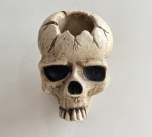 Gravelight skull wall candle holder with a lit candle