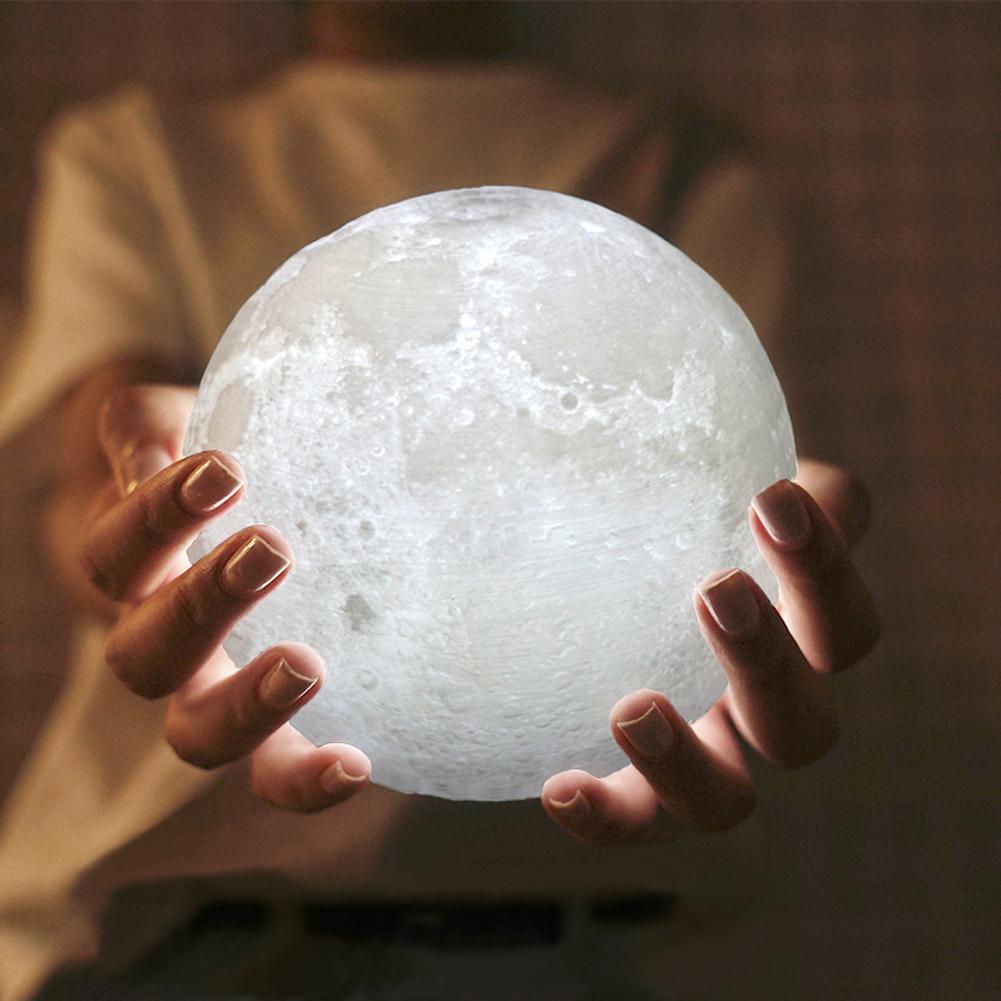 3D moon lamp glowing in cupped hands, witchy celestial gothic bedroom decor