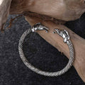 Antiqued silver torc armring with twisted cable band and dragon-head terminals, styled on driftwood