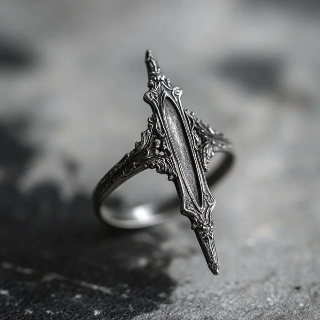 Antiqued silver double-thorn gothic ring, front view on dark stone