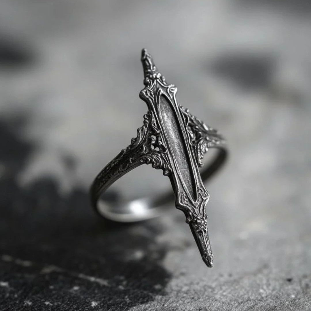 Antiqued silver double-thorn gothic ring, front view on dark stone