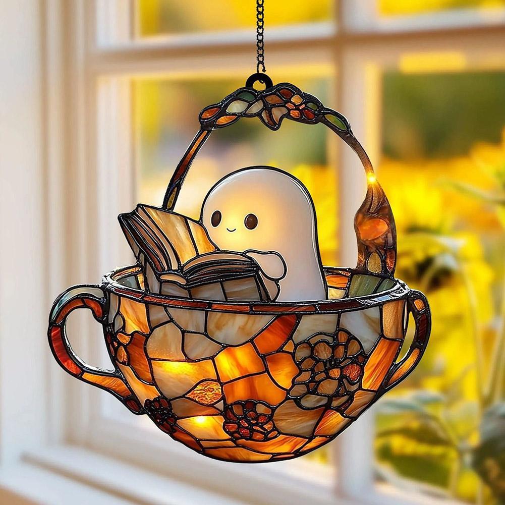 Stained-glass-style ghost suncatcher of a little specter reading a book, hanging in a window