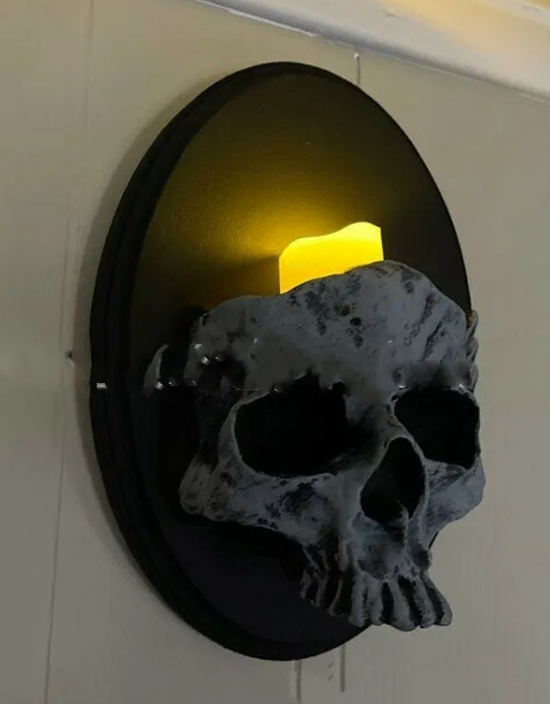 Gravelight cast-resin skull sconce mounted flat on a wall