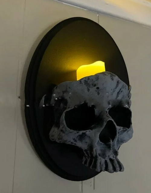 Gravelight cast-resin skull sconce mounted flat on a wall