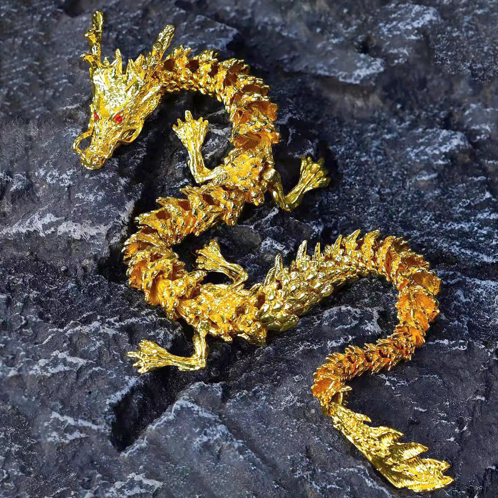 Aurelian articulated golden dragon coil posed on a desk