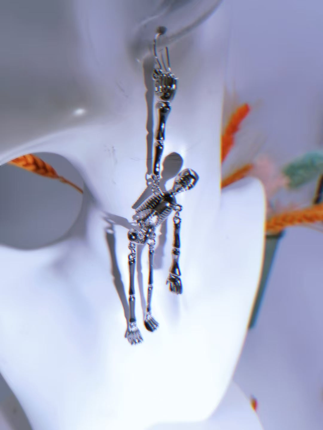 Skeleton dangle earring worn, showing articulated joints