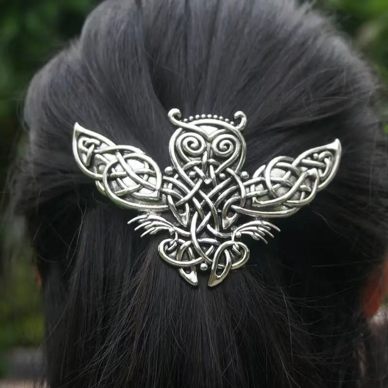 Antique silver Celtic knotwork owl hair fork worn in dark hair