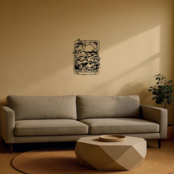 The Lovers skeleton tarot metal wall plaque hung above a sofa
