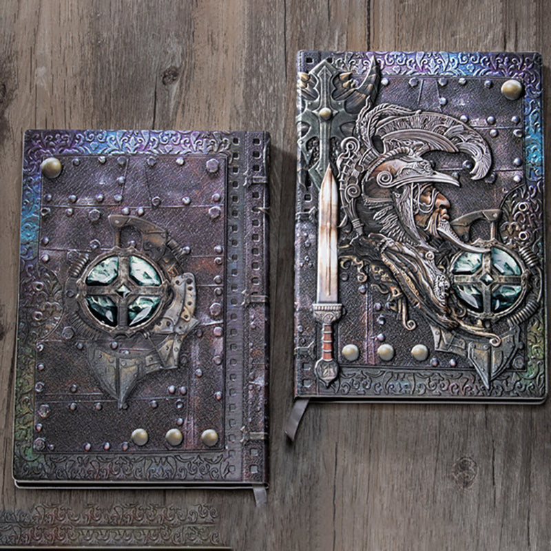 Two embossed metal-relief journals side by side on a wood surface