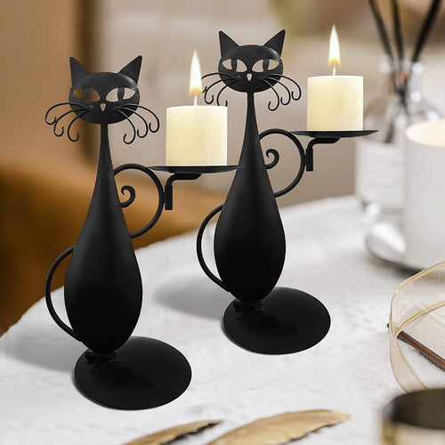 Black cat candlestick in cast iron holding a taper candle