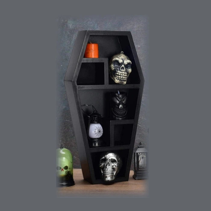 The Reliquary multi-cubby coffin-shaped wall shelf in black, styled with decor props (not included)