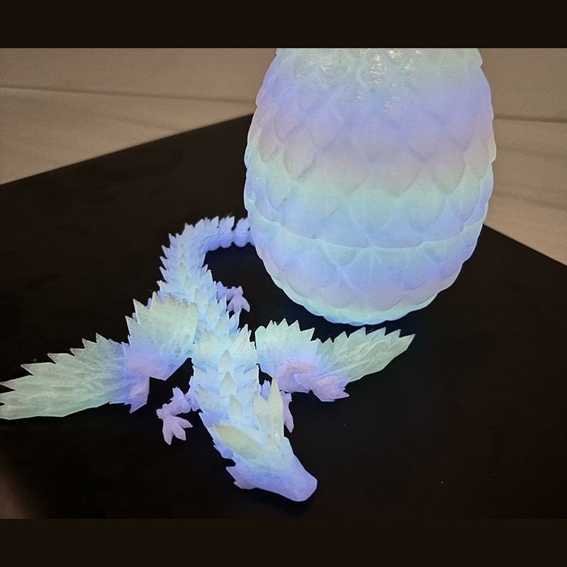 Glow-in-the-dark rainbow dragon egg and articulated dragon in pastel glow
